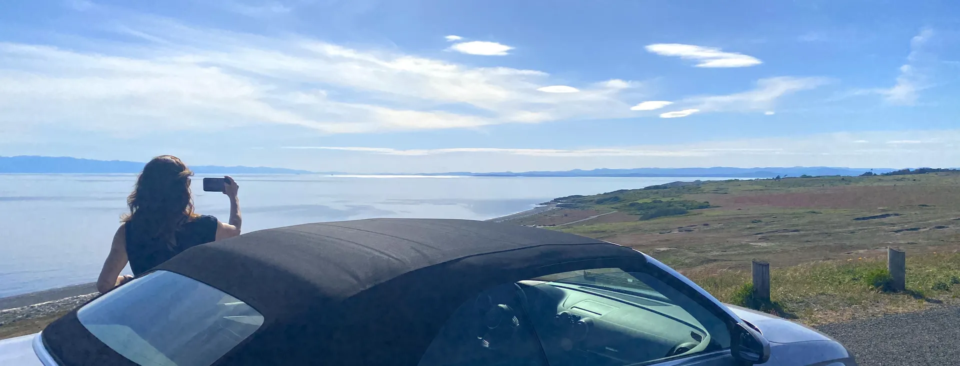 Woman taking scenic photo on San Juan Island, Washington