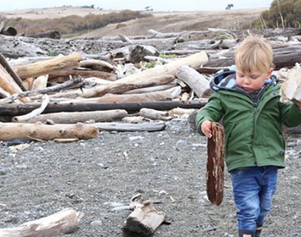 Boy walking on South Beach San Juan Island Washington
