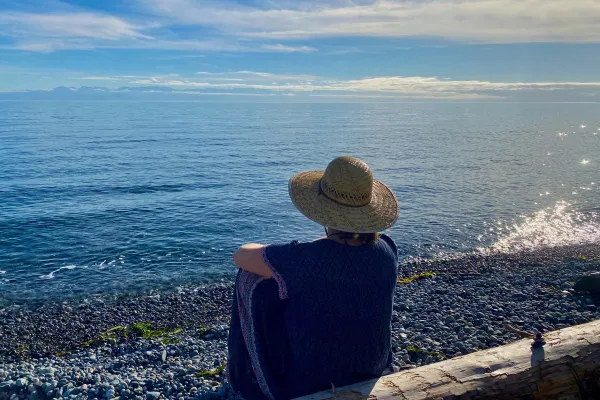 Woman on beach with hat