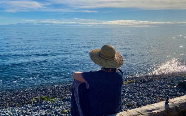 Woman on beach with hat