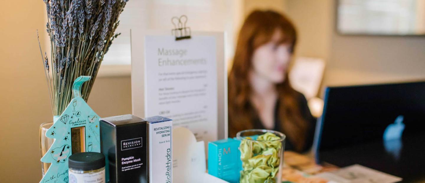 Receptionist at Earthbox Inn & Spa Front Desk with products